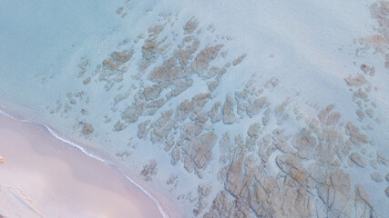Image taken from above of summer beach and clear blue and turquoise sea