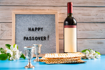 Celebrating spring holiday Passover. Bottle of wine and traditional Jewish matzo bread