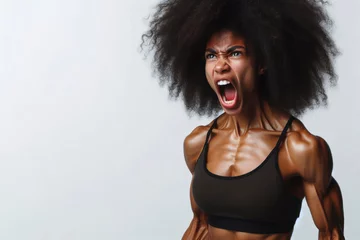 Fotobehang muscular afro woman with tense muscles and screaming copy space on a bright white background © Ольга Лукьяненко