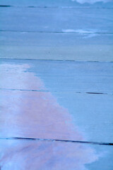A detailed image showcasing the texture of a blue painted wooden surface with visible brush strokes...