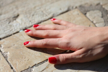 hand of young woman just got out of the manicure with red nail polish on nails - 785639761