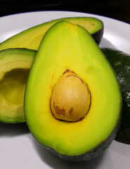 Green Ripe avocado halved ideal for preparing a tasty spread for toast and seed - 785642161