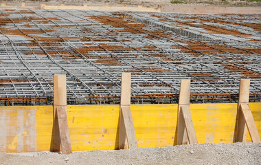 formwork made with yellow wooden planks during laying cement on the construction site without people - 785643103