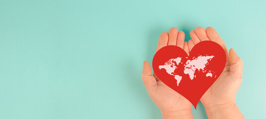 Red heart with world map, awareness of heart disease, humanitarian help, blood donor day, charity,...