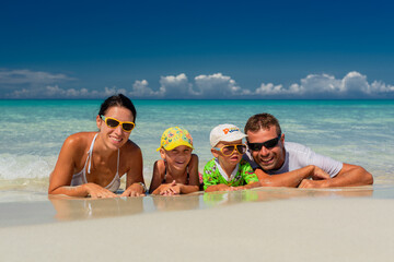 mom and dad with children, playing with kids, family on the beach, swimming in the ocean, vacations in warm countries, Caribbean sea, Atlantic ocean, Cuba, childhood, parents, daughter, son