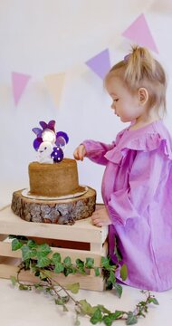 Little cute girl celebrate Happy Birthday. Cute girl blowing out a candle on a birthday cake at home