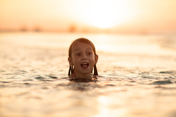 children swimming in shallow water, happy childhood, summer swimming, shallow water, girl, child,...