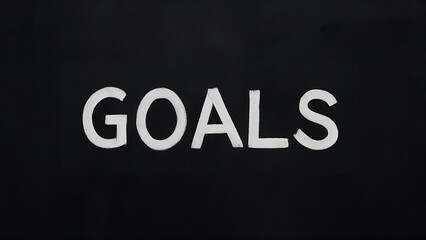  In a balck background, the words 'Goals' are written.