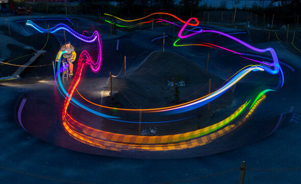 Nighttime bike ride with colorful light trails