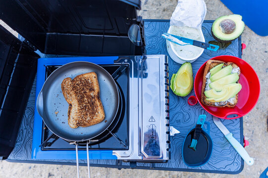 Outdoor camping breakfast with avocado and toast