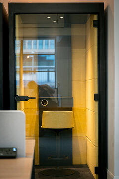 Modern office phone booth with stylish chair and lighting