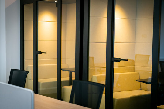 Modern office interior with glass partitions and furniture