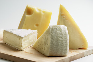 various types of cheese on wooden board