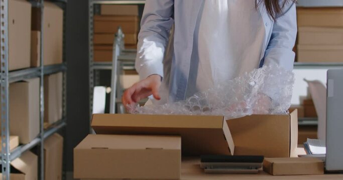 Business people, individual sellers starting small family business packing vase in cardboard, bubble wrap. Packing goods for safe transport, storing marketplace purchase delivery, fulfillment service
