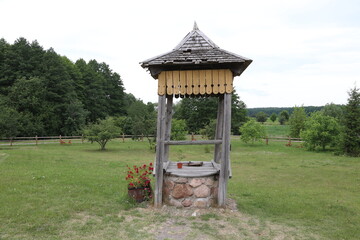 Old decorative well in the forest.
