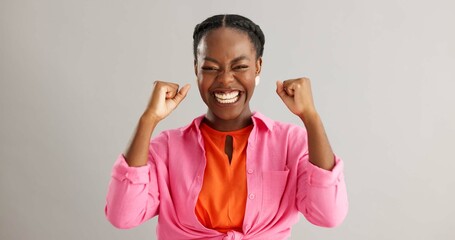 Yes, face and black woman with winner fist celebration in studio excited for competition results on...