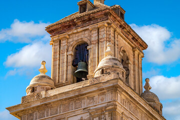 Detail of the bell tower of the parish of El Salvador, Caravaca, Murcia, Spain, in Renaissance style over blue sky