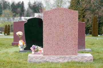 Several blank tombstones located in cemetery.