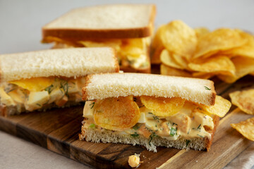 Homemade Egg Salad Sandwich with Potato Chips on a wooden board, side view. Close-up. - 785668359