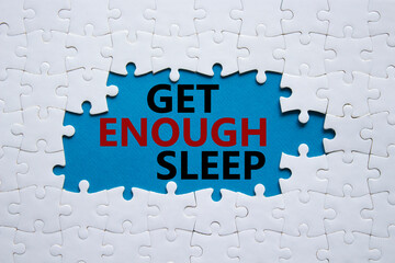 Get enough sleep symbol. White puzzle with words Get enough sleep. Beautiful blue background....