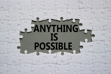 Anything is Possible symbol. White puzzle with words Anything is Possible. Beautiful grey...