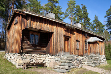 Old, traditional Norwegian wooden house with stone fundament and grass roof