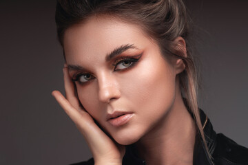 Portrait of woman with striking eye makeup and flawless skin