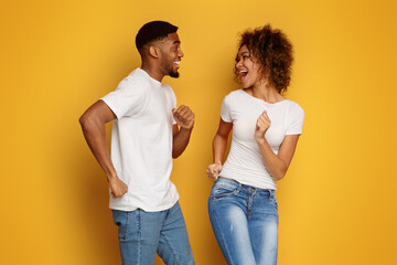 Cute african-american couple in love flirting and dancing together
