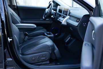 Interior of prestige modern electric car. Leather comfortable seats, dashboard and steering wheel....