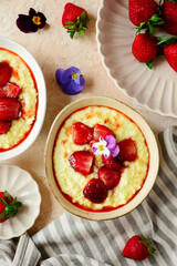 Creamy millet porridge with baked strawberries in to the bowl - 785683757
