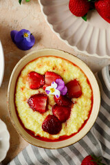 Creamy millet porridge with baked strawberries in to the bowl - 785683901