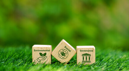 Environmental Social Governance word and icon on wooden cube over nature background, ESG concept, Ecology, sustainable business, Social Responsibility idea. - obrazy, fototapety, plakaty