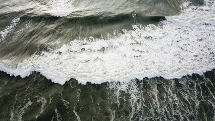 Aerial view of sandy beach and ocean with waves 