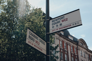 Street name signs on corner of Charing Cross road and Newport Court, London, UK.