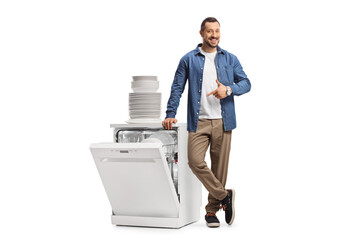 Guy pointing at a dishwasher and a pile of clean white plates