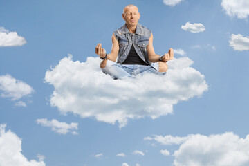 Bald man sitting corssed legged on a cloud