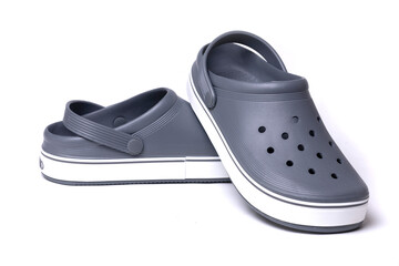 Gray crocs on a white background. Rubber shoes