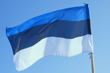Estonian Flag Fluttering Against Clear Blue Sky