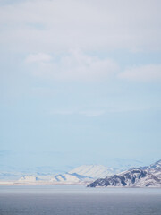 snow-covered mountains in distance and coldness sea