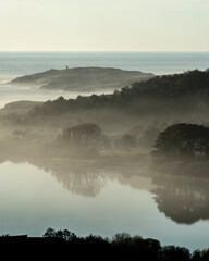 Coastal image with a fine mist that gives atmosphere to the scene. The Doniños lagoon (Spain) and...