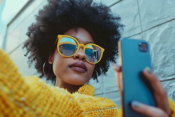 Woman in yellow with phone selfie