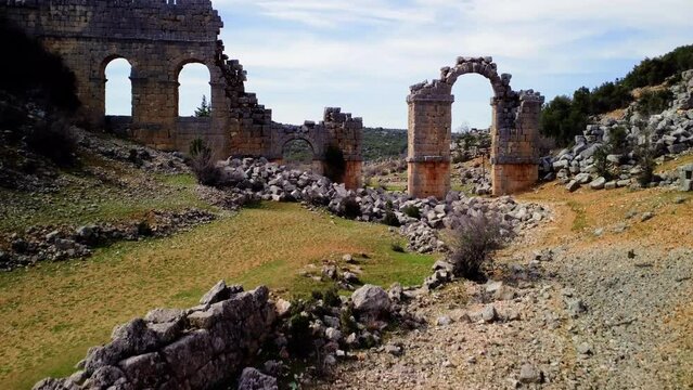 Drone video of Olba, Turkey, featuring ancient rome, gate, in ruins. Explore historic ancient rome, gate, from aerial view. Footage highlights ancient rome, gate, among ruins