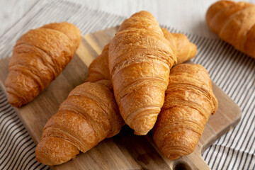 Homemade Breakfast Croissants on a Wooden Board, side view. - 785703385