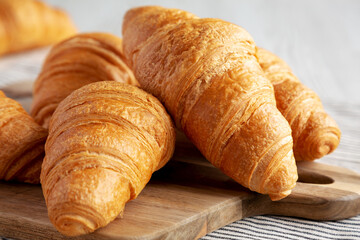 Homemade Breakfast Croissants on a Wooden Board, low angle view. Close-up. - 785703597