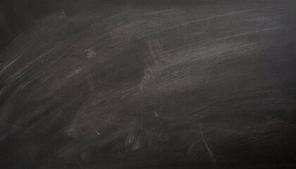 Black chalkboard with visible traces of erased chalk, showing a clean yet used texture. - obrazy, fototapety, plakaty