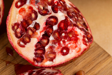juicy pomegranate on a wooden board