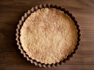 Top view of homemade pie crust on wooden table. Fresh dessert concept.