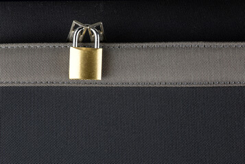 Small Brass Padlock on a Zippered Suitcase Pocket - 785706339