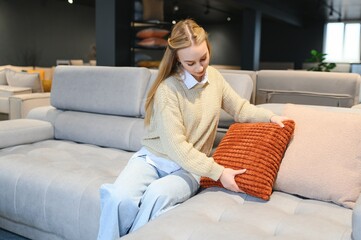 Obraz premium young woman shopping for furniture, sofa and home decor in store