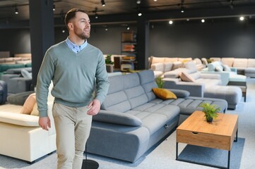 man chooses furniture in a store